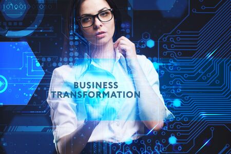 The concept of business, technology, the Internet and the network. A young entrepreneur working on a virtual screen of the future and sees the inscription: Business transformationの写真素材
