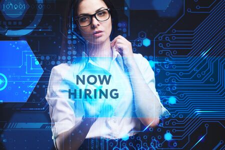 The concept of business, technology, the Internet and the network. A young entrepreneur working on a virtual screen of the future and sees the inscription: Now hiringの写真素材