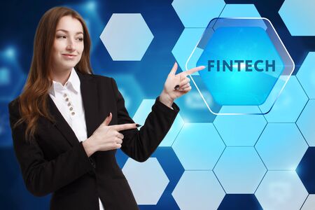The concept of business, technology, the Internet and the network. A young entrepreneur working on a virtual screen of the future and sees the inscription: Fintechの写真素材