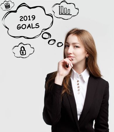 Technology, internet and network. A young entrepreneur is thinking how to become successful and protect your business: 2019 goalsの写真素材
