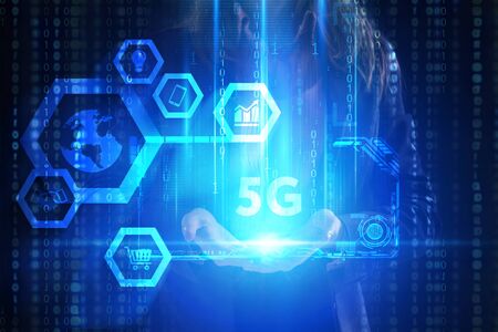 The concept of business, technology, the Internet and the network. A young entrepreneur working on a virtual screen of the future and sees the inscription: 5Gの写真素材