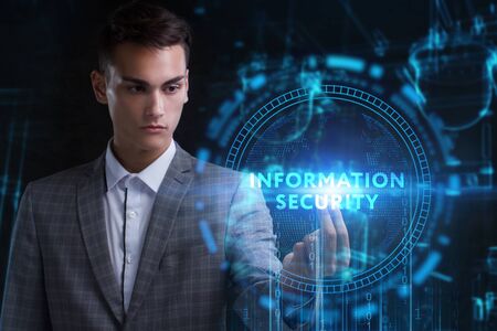 The concept of business, technology, the Internet and the network. A young entrepreneur working on a virtual screen of the future and sees the inscription: Information securityの写真素材
