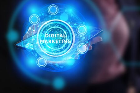 The concept of business, technology, the Internet and the network. A young entrepreneur working on a virtual screen of the future and sees the inscription: digital marketingの写真素材