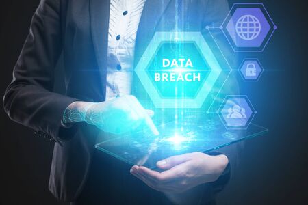Business, Technology, Internet and network concept. Young businessman working on a virtual screen of the future and sees the inscription: Data breachの写真素材
