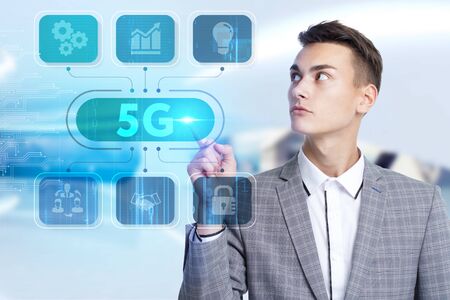 Business, Technology, Internet and network concept. Young businessman working on a virtual screen of the future and sees the inscription: の写真素材