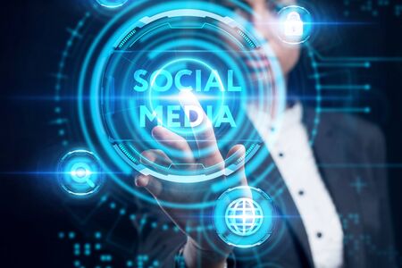 Business, Technology, Internet and network concept. Young businessman working on a virtual screen of the future and sees the inscription: Social mediaの写真素材