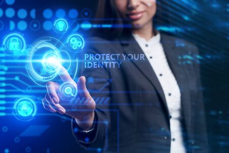 Business, Technology, Internet and network concept. Young businessman working on a virtual screen of the future and sees the inscription: Protect your identityの写真素材