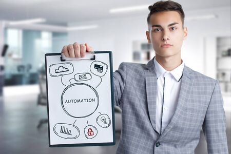 Business, Technology, Internet and network concept. Young businessman working on a virtual screen of the future and sees the inscription: Automationの写真素材