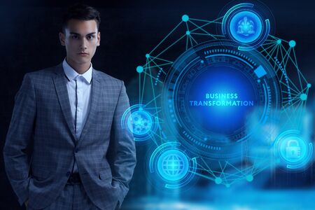Business, Technology, Internet and network concept. Young businessman working on a virtual screen of the future and sees the inscription: Business transformationの写真素材