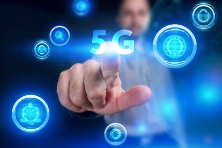 Business, Technology, Internet and network concept. Young businessman working on a virtual screen of the future and sees the inscription: 5Gの写真素材