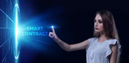 Business, Technology, Internet and network concept. Young businessman working on a virtual screen of the future and sees the inscription: Smart contractの写真素材