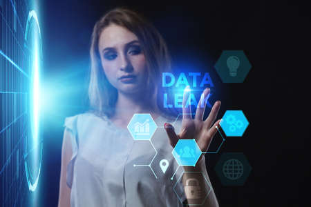 Business, Technology, Internet and network concept. Young businesswoman working on a virtual screen of the future and sees the inscription: Data leakの写真素材