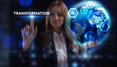 Business, Technology, Internet and network concept. Young businessman working on a virtual screen of the future and sees the inscription: Transformationの写真素材