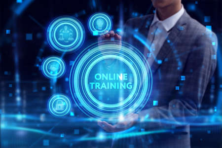 Business, Technology, Internet and network concept. Young businessman working on a virtual screen of the future and sees the inscription: Online trainingの写真素材