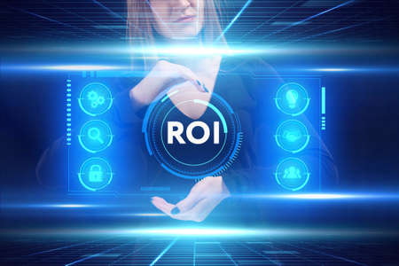 Business, Technology, Internet and network concept. Young businessman working on a virtual screen of the future and sees the inscription: ROIの写真素材