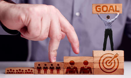 Business, Technology, Internet and network concept. Young businessman shows the word: goalの写真素材