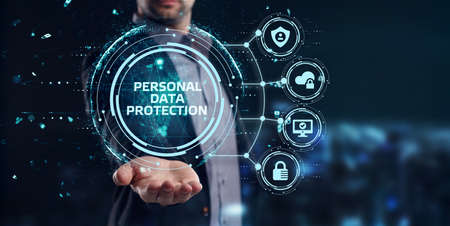 Cyber security data protection business technology privacy concept. Young businessman select the Personal data protection on the virtual display.の写真素材