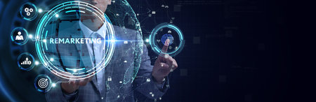 The concept of business, technology, the Internet and the network. A young entrepreneur working on a virtual screen of the future and sees the inscription: Remarketingの写真素材