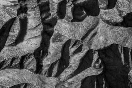 Light and shadows - Black and white aerial top down view on pattern generated by sandstone mountains in Zhangye National Geopark, Chinaの写真素材