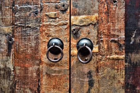 Traditional Chinese door handles on a wooden door. Textured surface.