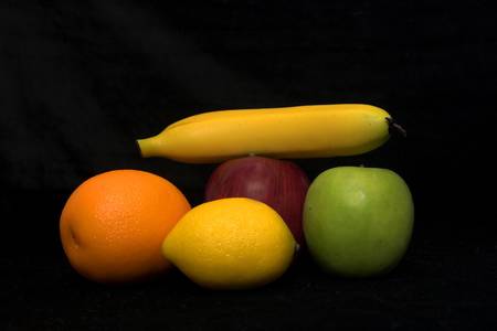 Healthy, vibrant,  looking fruits isolated over blackの写真素材