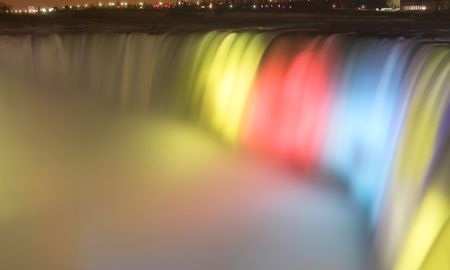 Niagara Falls lit up at night with a wonderful array of colorsの写真素材