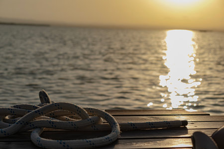 Sunset from a dock with a ship's headland in the foregroundの写真素材