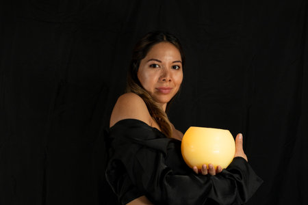latina woman posing on camera with black backgroundの写真素材