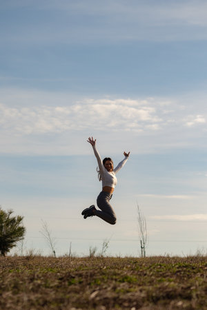 Young woman jumping suspended in the airの写真素材