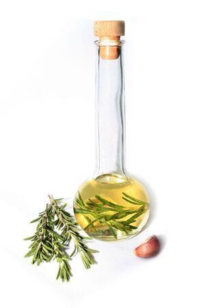 Rosemary oil with rosemary and garlic on a whtie background