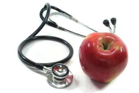 Stethoscope with apple on a white backgroundの写真素材