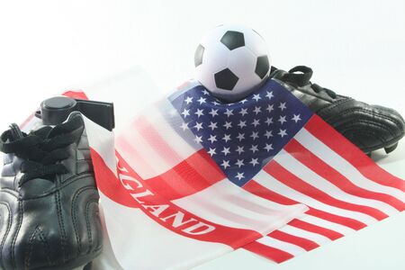 Football boots and leather ball with flags on a white backgroundの写真素材