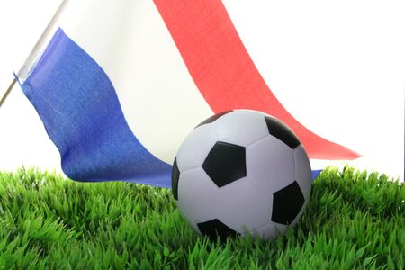 Flag of Netherlands with a football in a fieldの写真素材