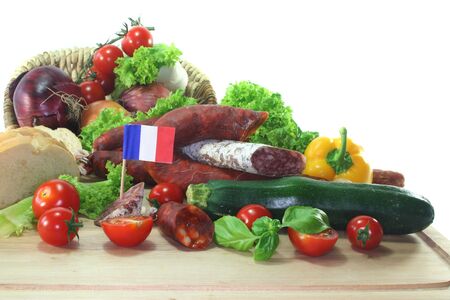 French air-dried salami with vegetables and herbsの写真素材