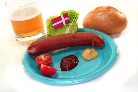 Danish sausage with ketchup, mustard, salad, bread and beerの写真素材