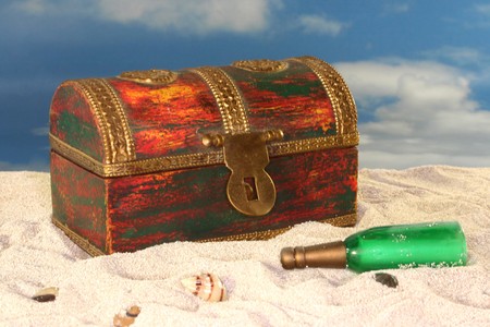 old treasure chest with a bottle post on the beachの写真素材