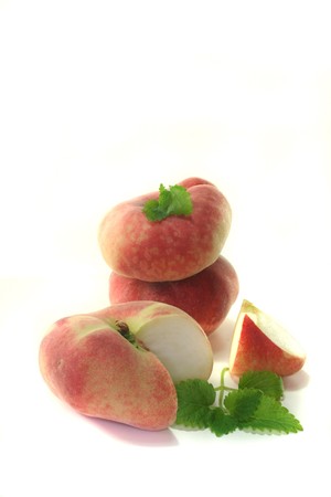 bleed fresh mountain peaches with lemon balm on a white backgroundの写真素材