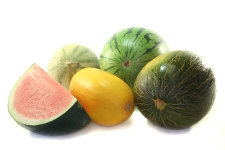 different varieties of fresh melons on a white backgroundの写真素材
