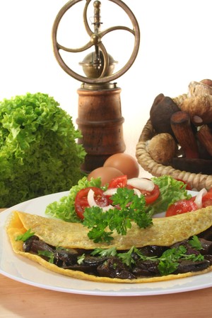 an omelet stuffed with wild mushrooms and fresh saladの写真素材