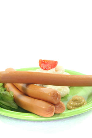 Wiener Sausage with potato salad and lettuce on a white backgroundの写真素材