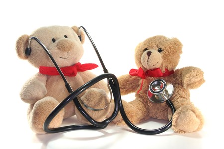 Teddy-doctor and Teddy-child listens on a white backgroundの写真素材