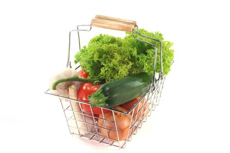 Colorful mixture of vegetables in the Shopping basket on a white backgroundの写真素材