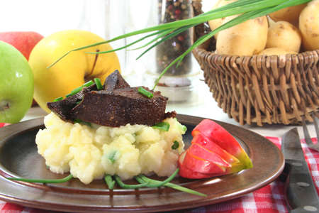 fried liver with mashed potatoes, apple and chivesの写真素材