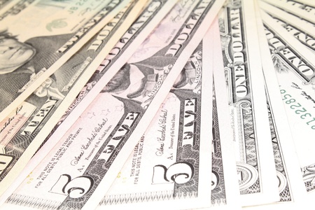 a stack of many colorful dollar notes
