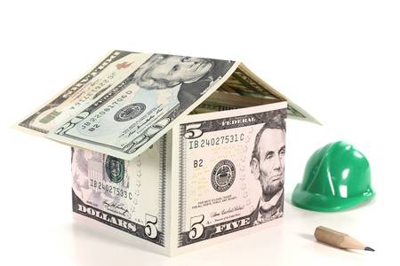 House of dollar bills with construction helmet and pencilの写真素材