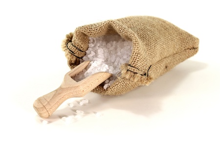 salt grains on a bushel with sea salt in the bagの写真素材