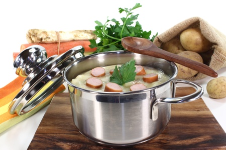 Potato soup with Wiener sausage, greens and parsleyの写真素材