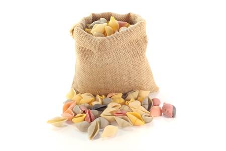 handful of colorful noodles in a bag on white backgroundの写真素材