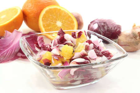 red chicory salad with orange slices and dressingの写真素材