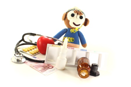 Pediatrician - with crochet monkey, money, medicine box, stethoscope and pillsの写真素材